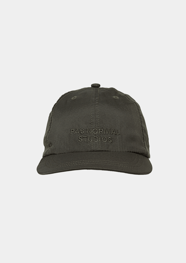 Front view of the Pas Normal Studios Balance Cap in the color dark olive green. Six panel construction and ultra light nylon fabric. Featuring a vented opening on the back and completed with a toggled drawstring, the cap is highly breathable and close-fitting, making it nearly undetectable during use.