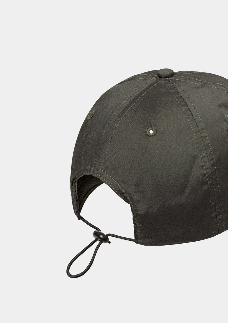 Back side view of the Pas Normal Studios Balance Cap in the color dark olive green. Six panel construction and ultra light nylon fabric. Featuring a vented opening on the back and completed with a toggled drawstring, the cap is highly breathable and close-fitting, making it nearly undetectable during use.