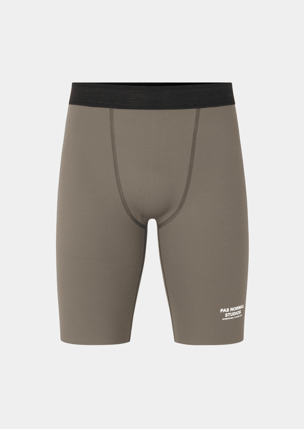 Front view of the Pas Normal Studios Men’s Balance Short Tights in the color stone. Perforated elastic waistband and tight fit with Pas Normal Studio font logo in white on lower left side. 