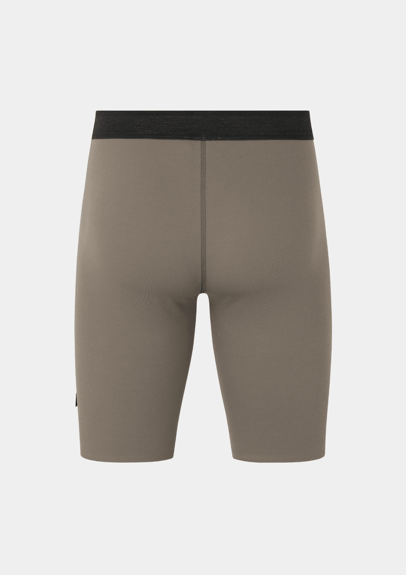 Back side view of the the Pas Normal Studios Men’s Balance Short Tights in the color stone. Perforated elastic waistband and tight fit. No logo markings on the back of the shorts.