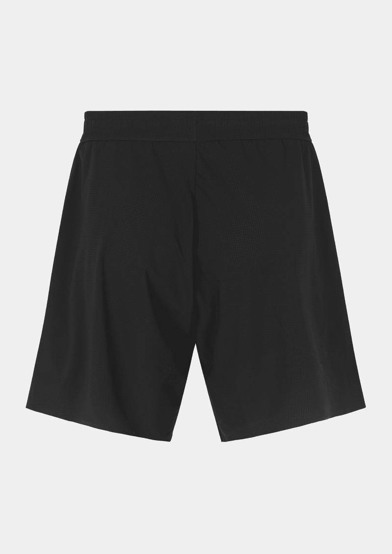 Back side view of the the Pas Normal Studios Men’s Balance Shorts in the color black. Adjustable elastic waistband and tight fit. No logo markings on the back of the shorts. Not tight fitting.