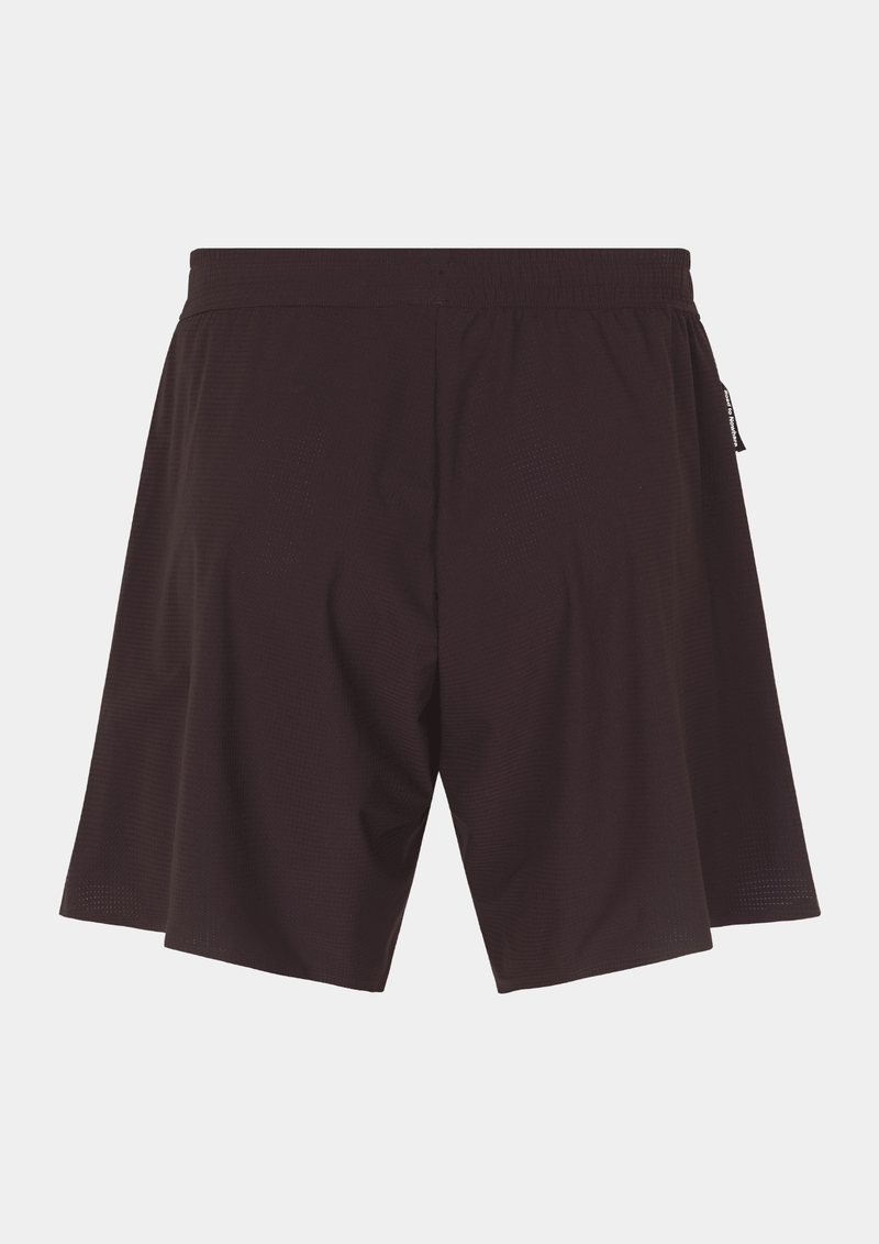 Back side view of the the Pas Normal Studios Men’s Balance Shorts in the color dark red. Adjustable elastic waistband and tight fit. No logo markings on the back of the shorts.