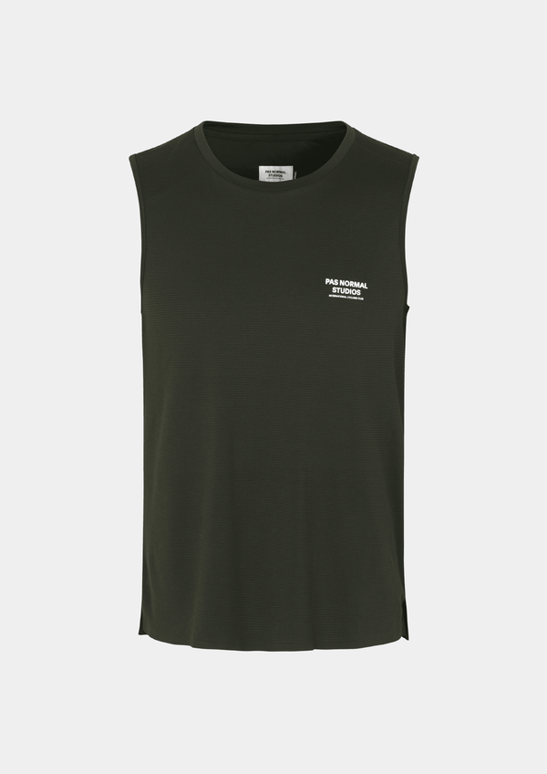 Front view of the Pas Normal Studios Men’s Balance Sleeveless Top in the color dark olive green. Knit construction and split hem vents. Pas Normal Studios text logo in white on front left breast of shirt. 