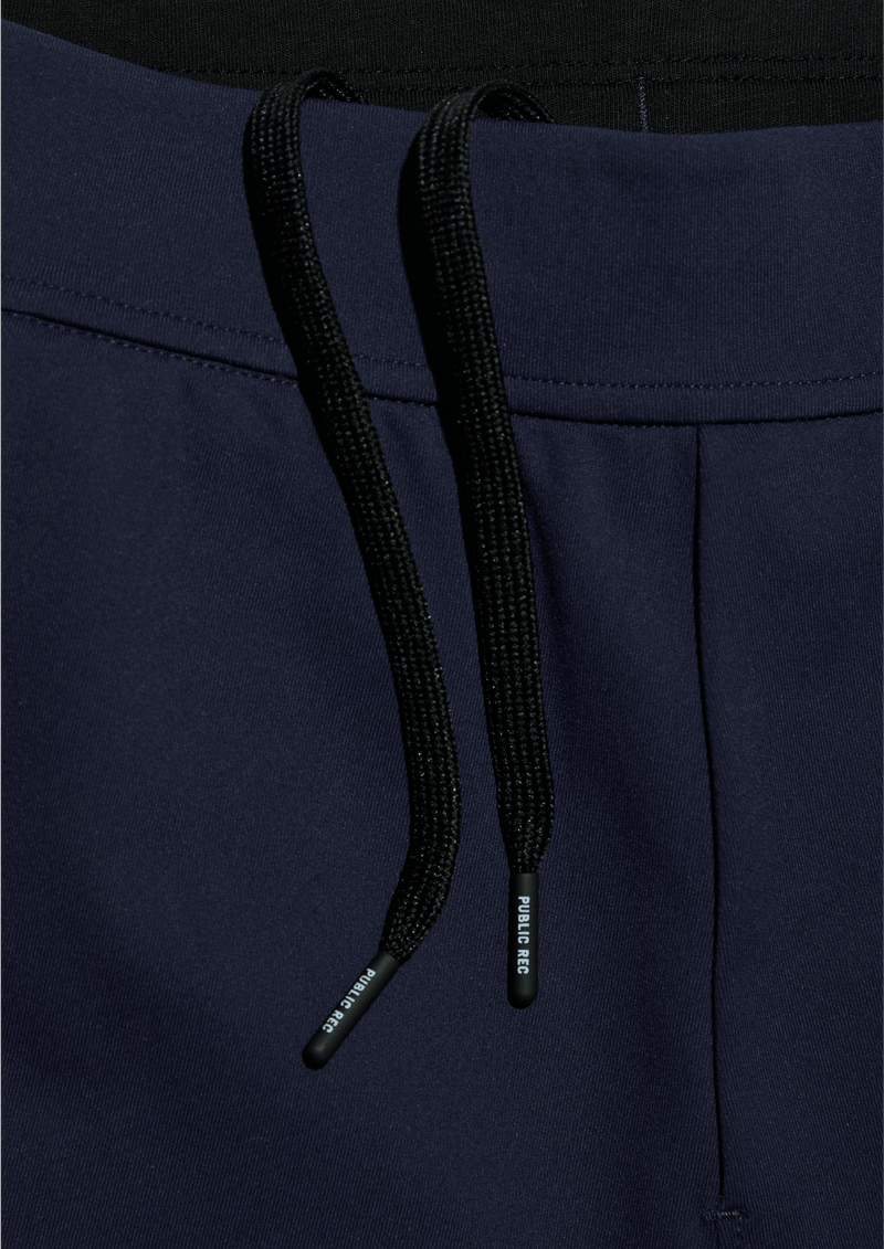 Mens Public Rec All Day Every Day Jogger pant with cuffed ankle in the color navy blue. Detail of the elastic waistband with internal drawstring.