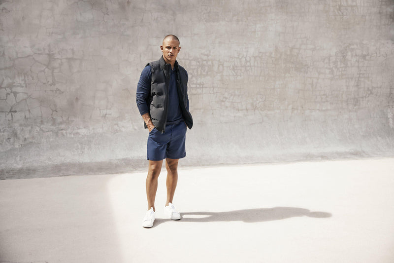 Mens Public Rec Go-To Henley Long Sleeve | Heather Navy - styled on a man in the Mens Public Rec Flex Short and the Mens Public Rec Better Than Down vest