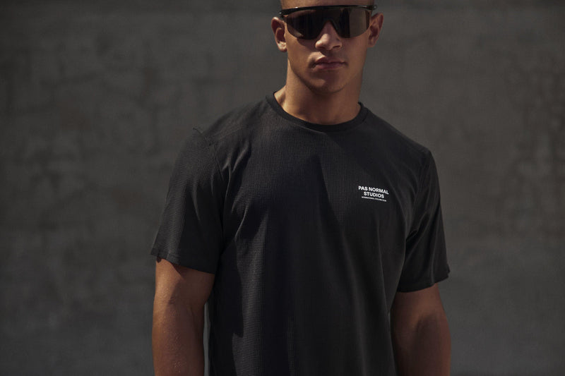Pas Normal Studios Men’s Balance Short Sleeve Top -  styled on a man in sunglasses