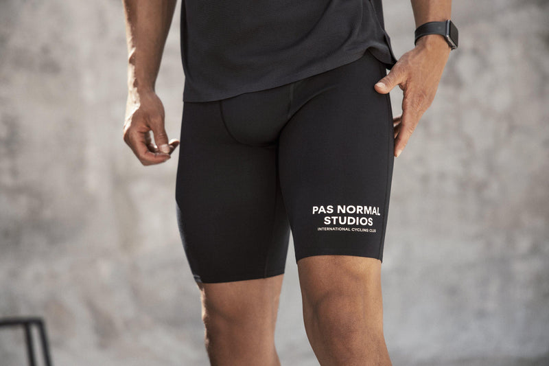 Pas Normal Studios Men’s Balance Short Tights in the color black - styled on a man about to go on a run